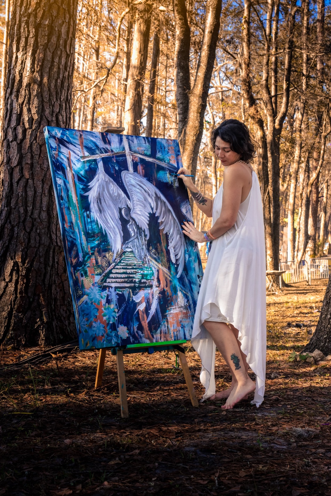 Tina Cozart at work beside one of her large paintings