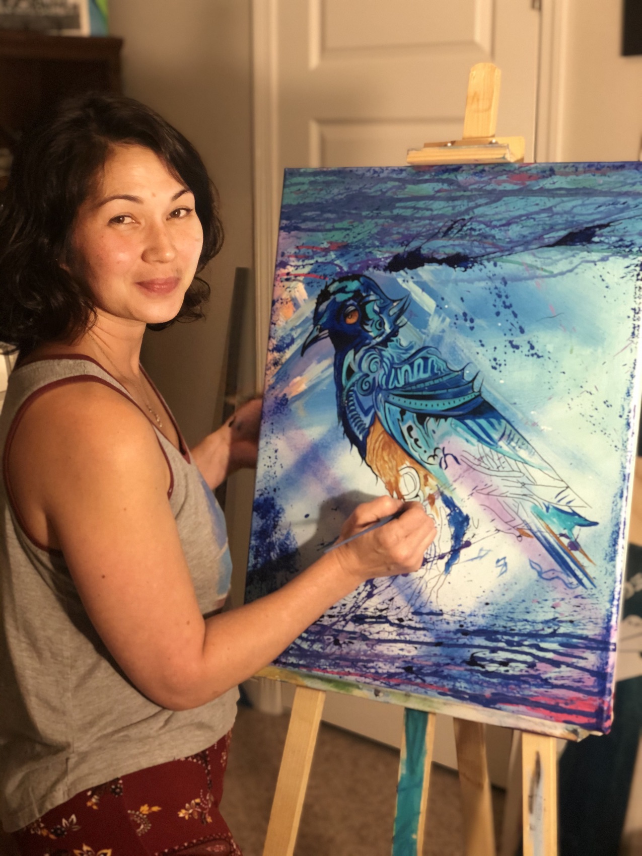 Tina Cozart painting at her easel