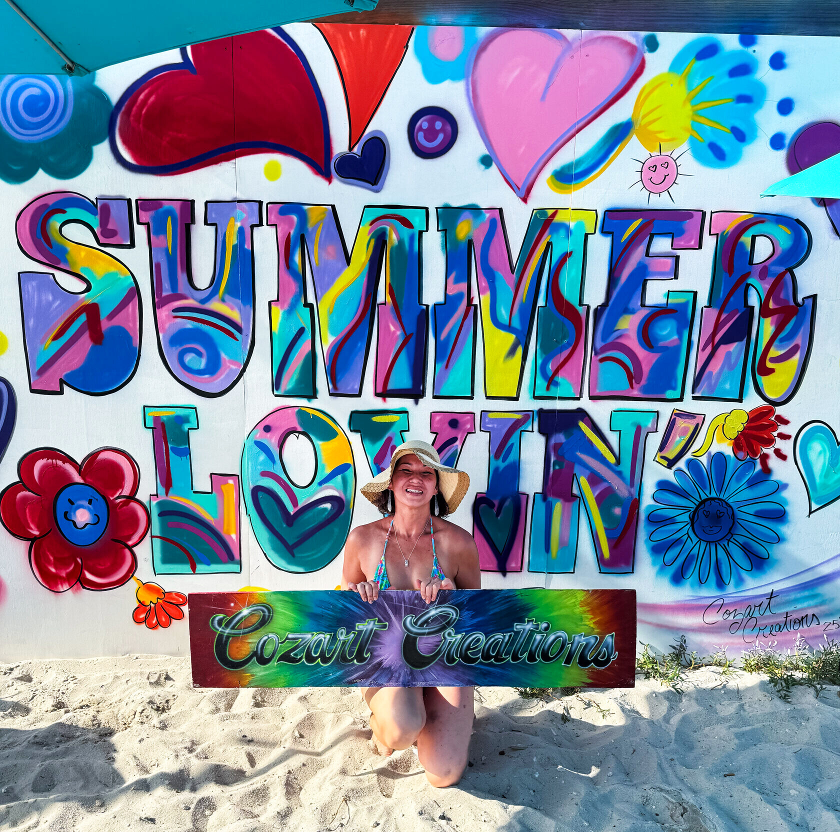 Artist Tina Cozart in front of her ‘Summer Lovin’’ mural in daylight