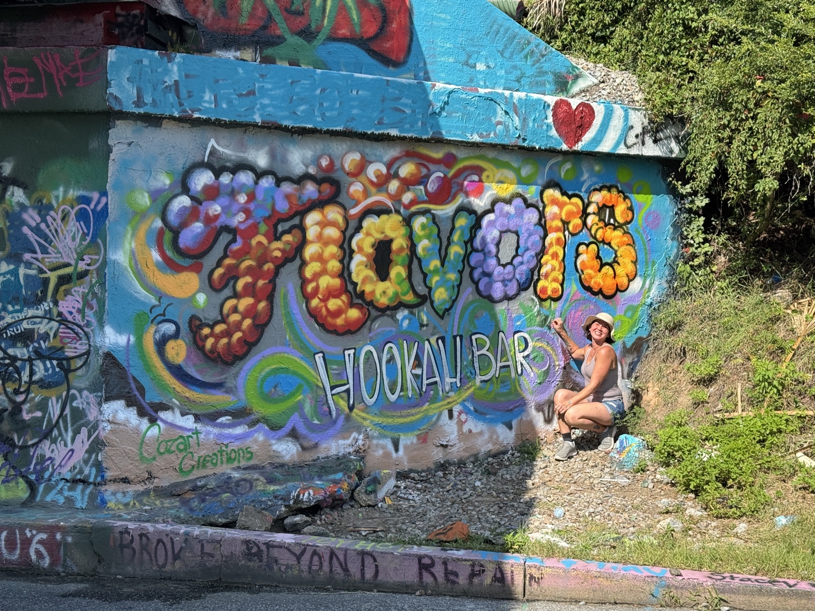 Graffiti-style bubble-letter mural reading 'Flavors', hand-painted by Tina Cozart